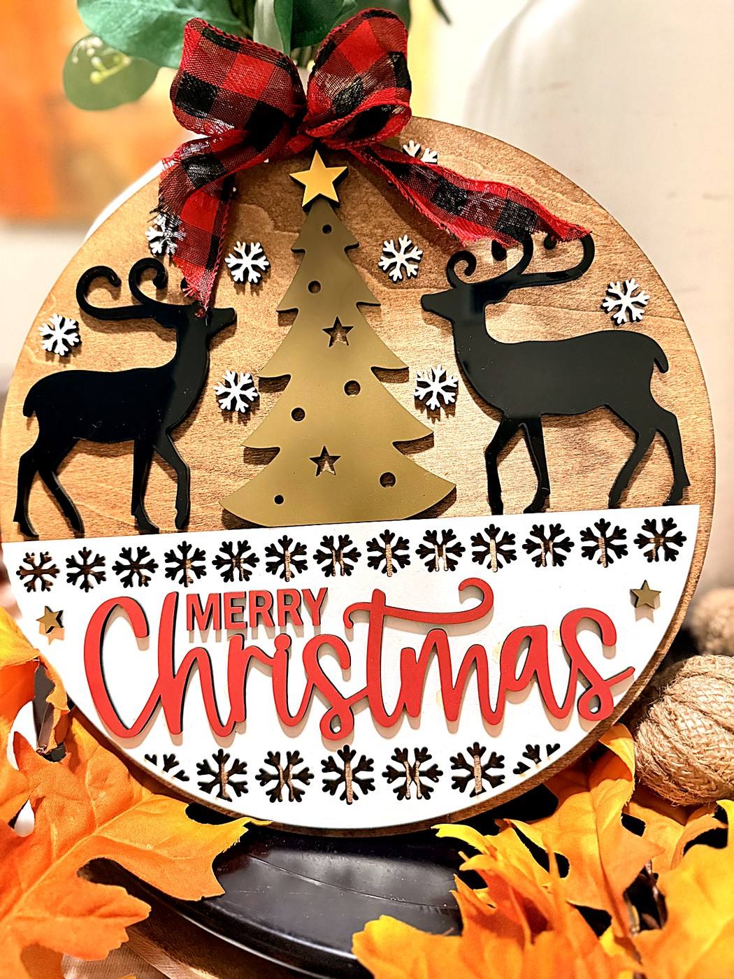 Round Merry Christmas sign with reindeer and a gold tree