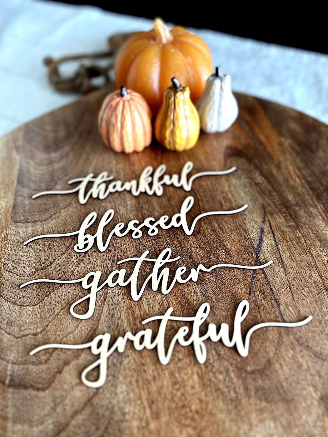 Wooden fall decorations reading thankful, blessed, gather, and grateful