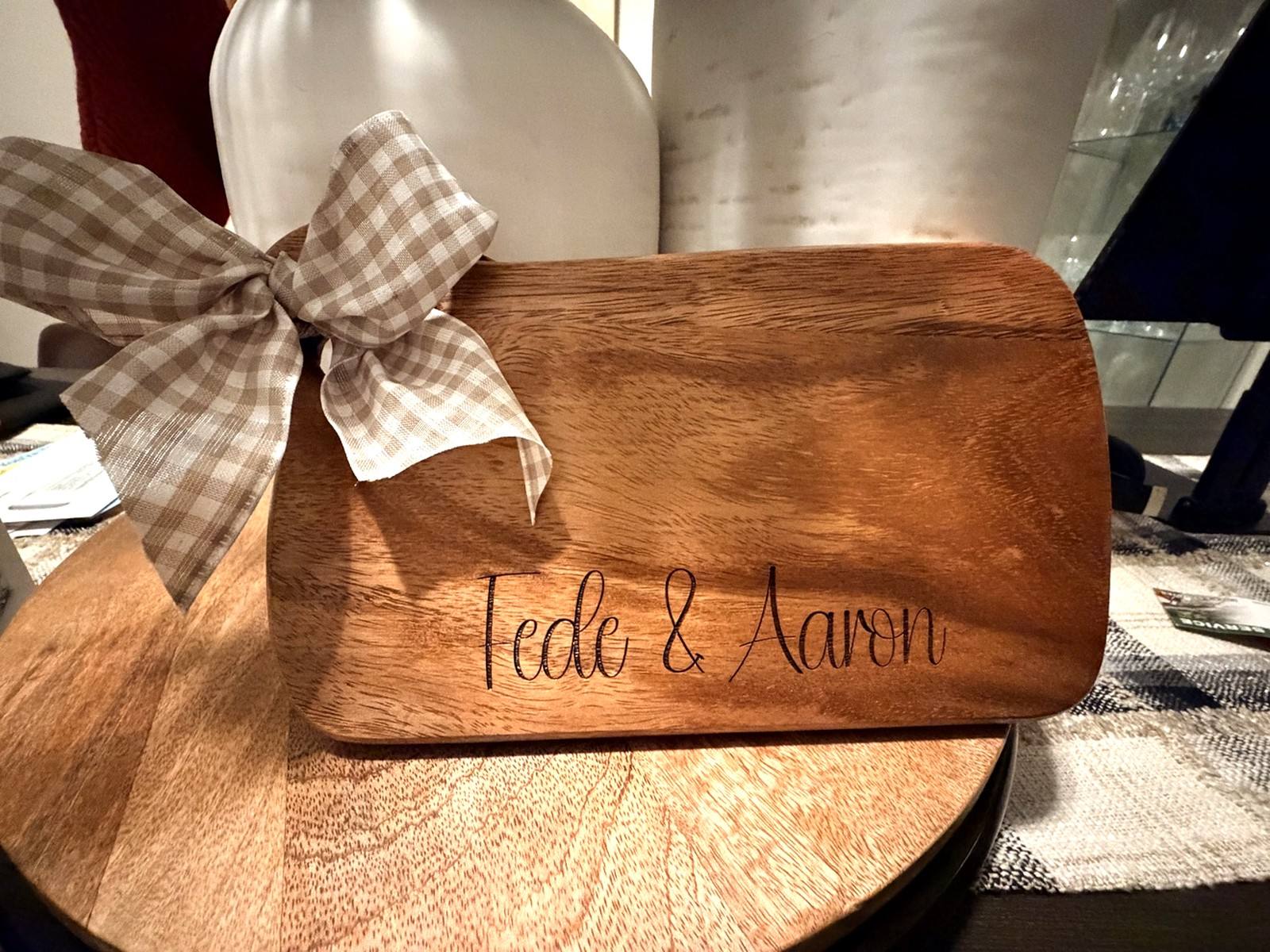 Wooden board engraved for Fede and Aaron and decorated with a bow
